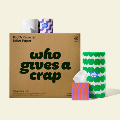 Two rolls and a box of Who Gives a Crap compostable rubbish bags with green packaging