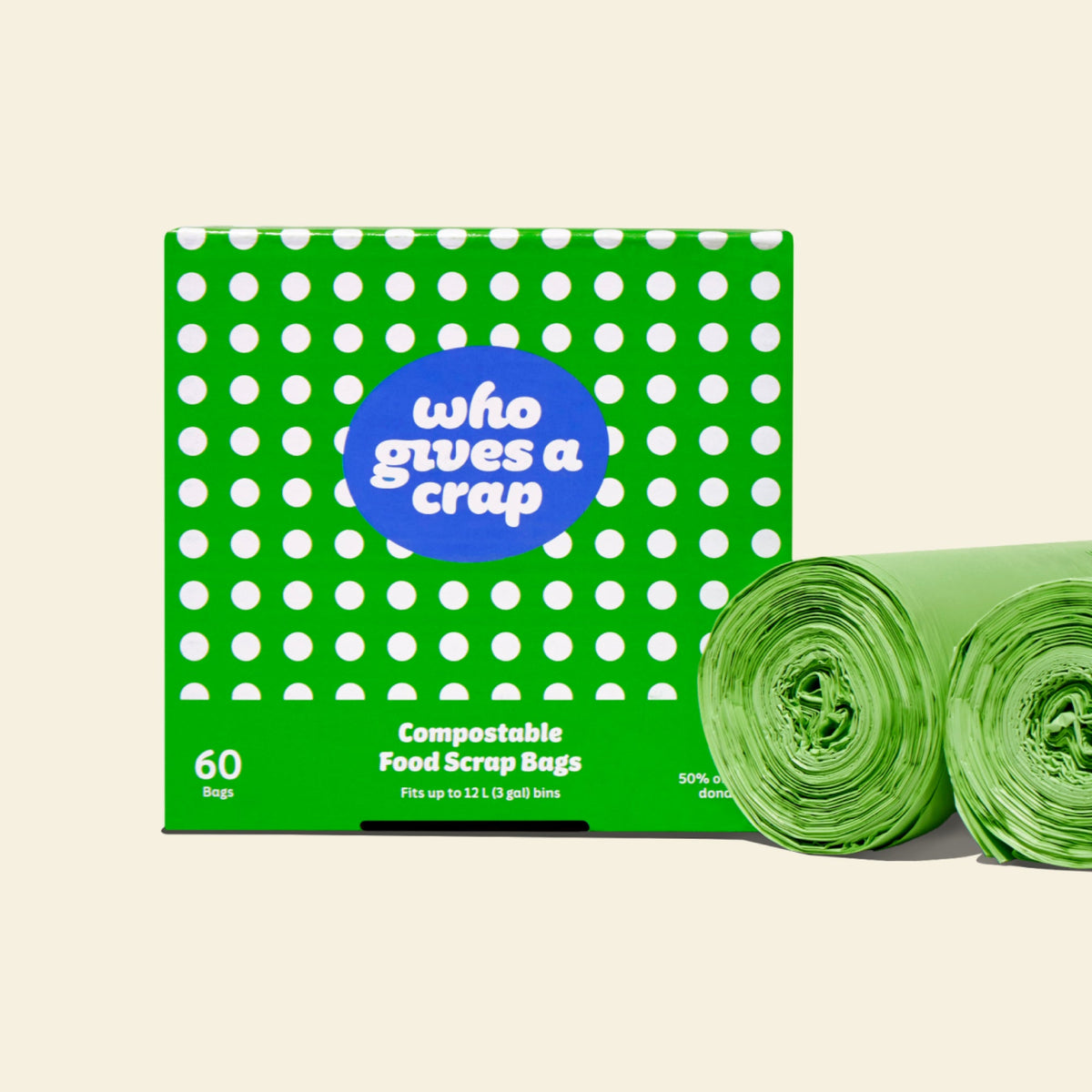 Two rolls and a box of Who Gives a Crap compostable rubbish bags with green packaging