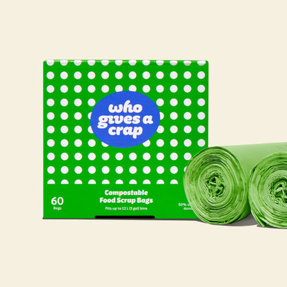 Two rolls and a box of Who Gives a Crap compostable rubbish bags with green packaging