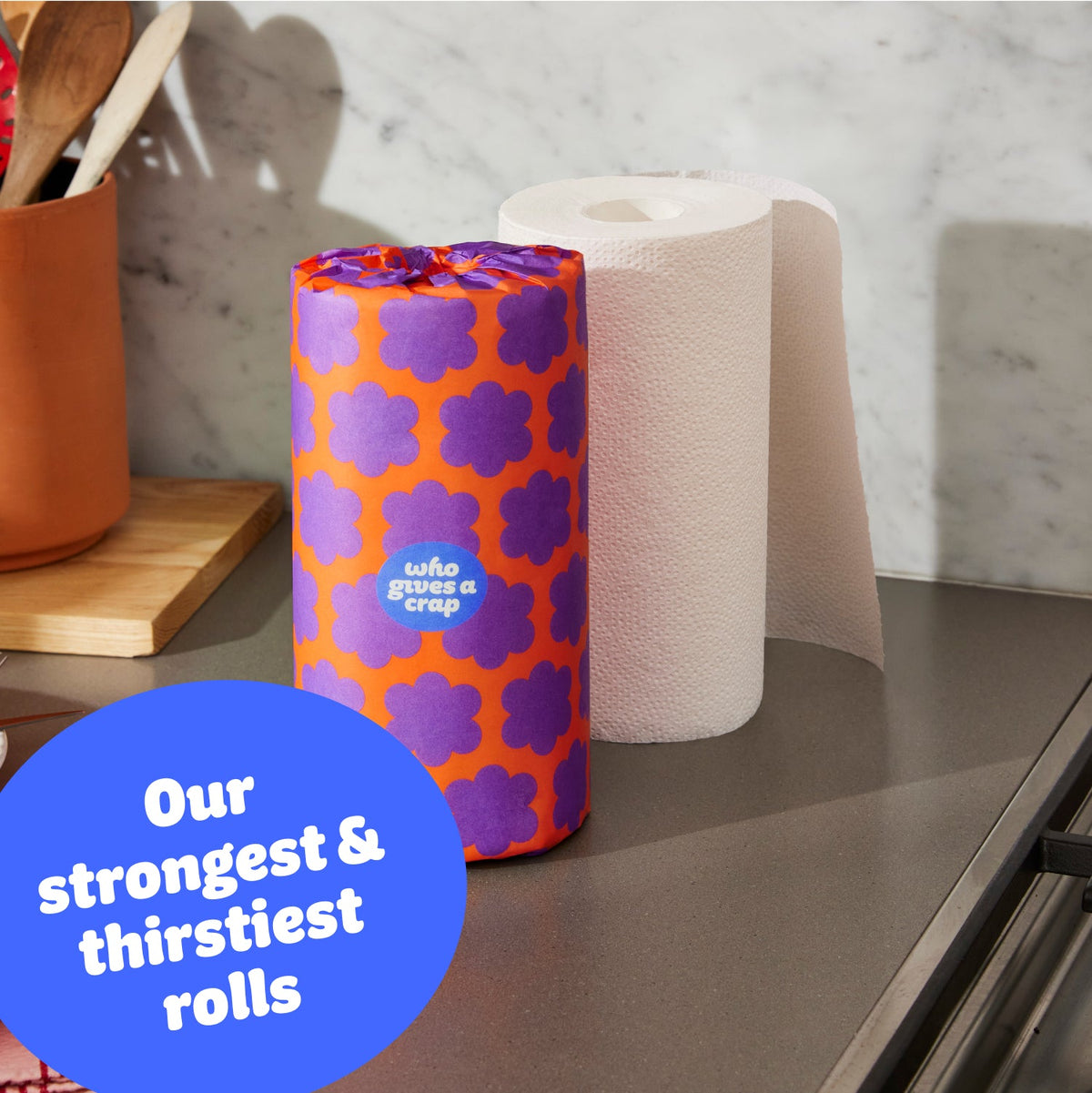 Single roll of Who Gives a Crap paper towel on kitchen bench with sticker that says our strongest and thirstiest rolls
