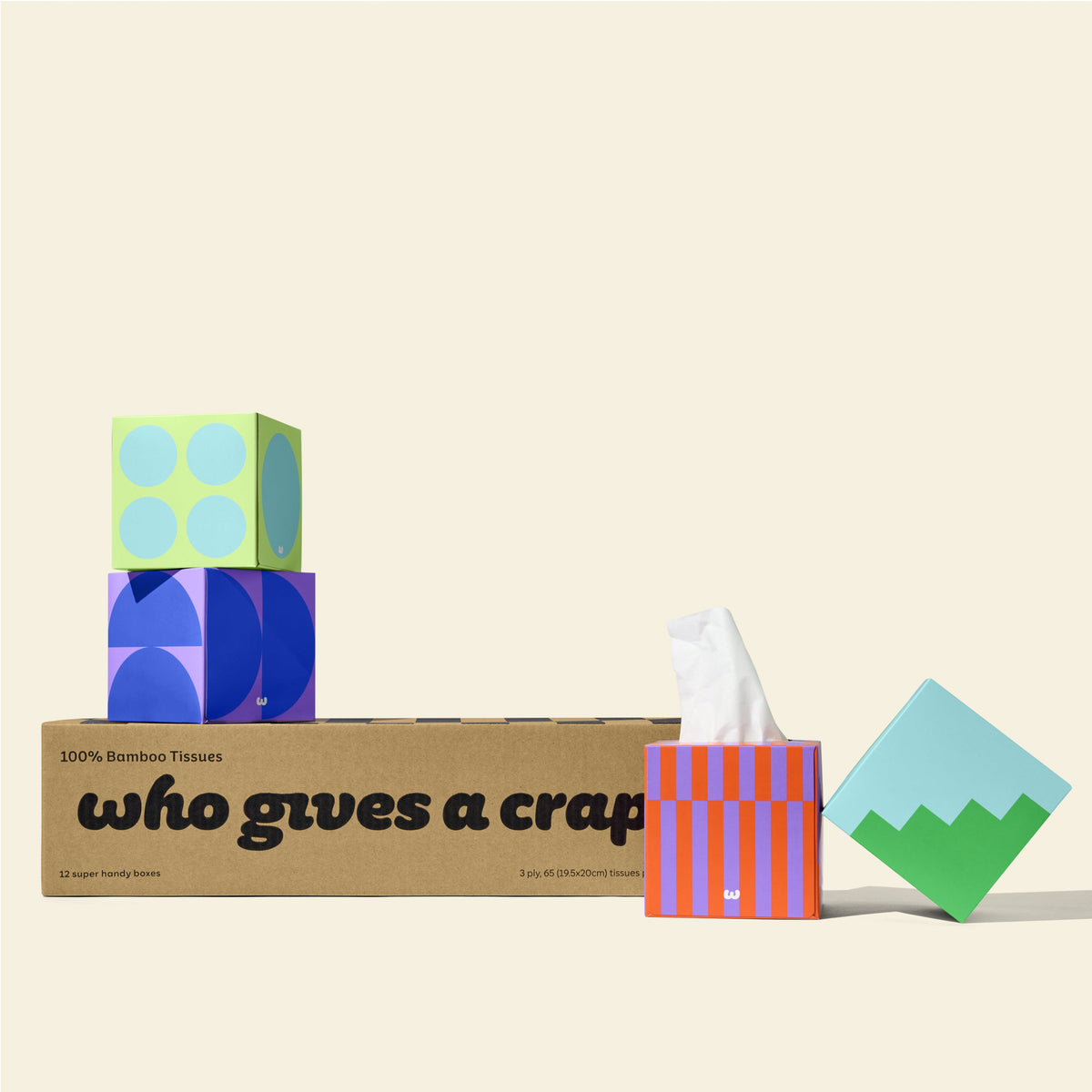 Box of twelve 100% bamboo, 3 ply Who Gives a Crap tissue paper with four colourful boxes sitting on top.