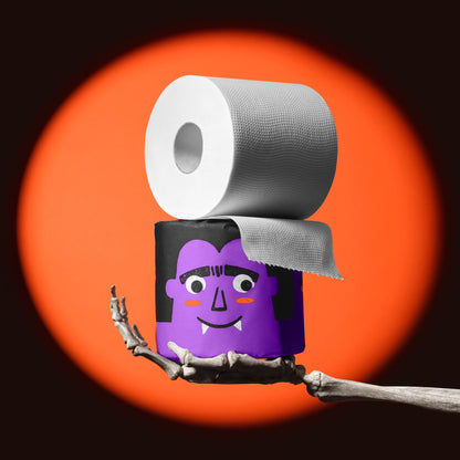 Skeleton hand holding a purple vampire roll of Spooky Edition bamboo toilet paper, unravelling in an orange spotlight